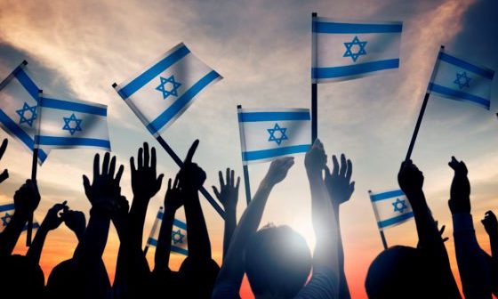 41400539 silhouettes of people holding flag of israel